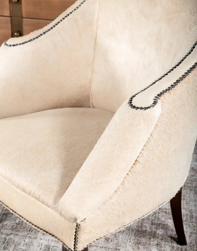 Close-up detail of the natural cowhide upholstery on the Hertfordshire Sand Cowhide Chair, displaying its texture and unique patterns.