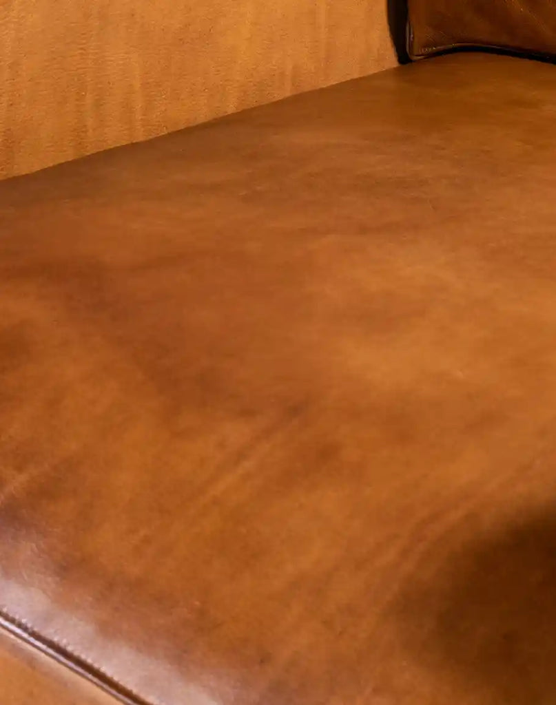 Close-up of the specially-treated leather on the Stockman Leather Chair with its natural worn look.