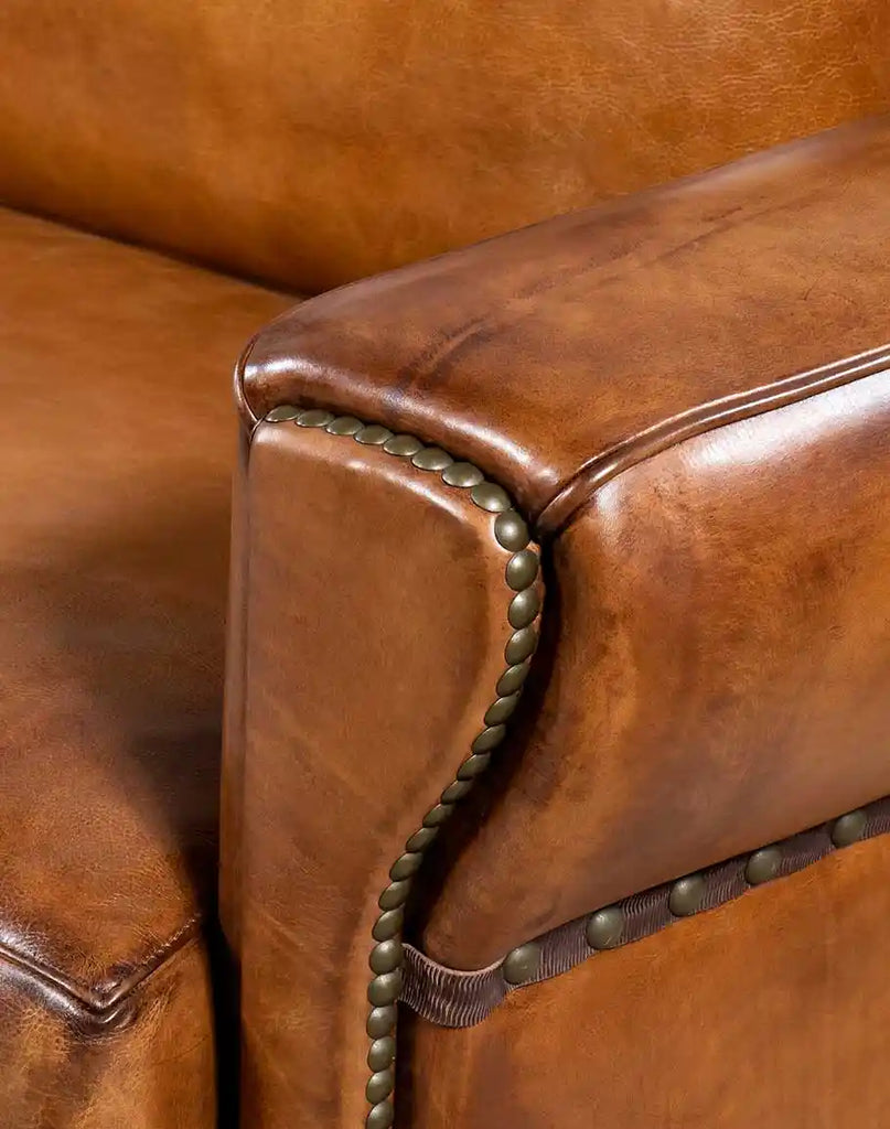 Detailed close-up of the Herdsman Leather Sofa's signature tapered armrest, showcasing its ergonomic design and smooth leather finish.