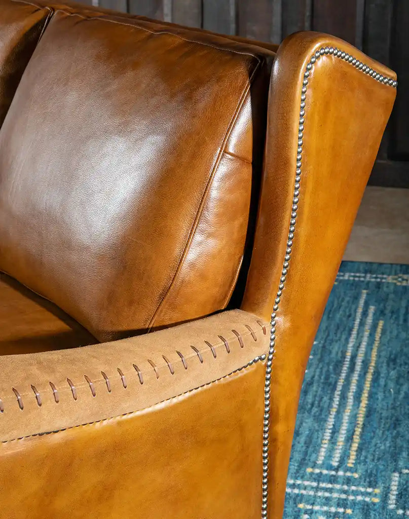 A detailed close-up of the premium full-grain leather upholstery on the Norse Leather Sofa, highlighting its texture and craftsmanship.