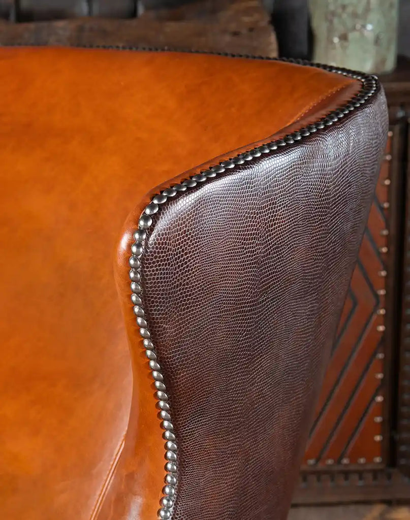 A detailed view of the nickel nail head trim outlining the arms and wings, enhancing the chair’s elegance.