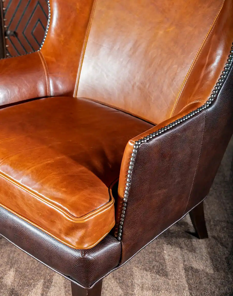 Angled side view of the chair, showcasing its smooth leather upholstery and refined craftsmanship.