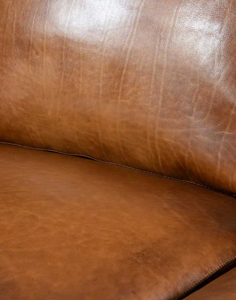 Close-up view of the hand-burnished leather upholstery on the Colorado Leather Sofa, emphasizing its natural patterns and luxurious texture.