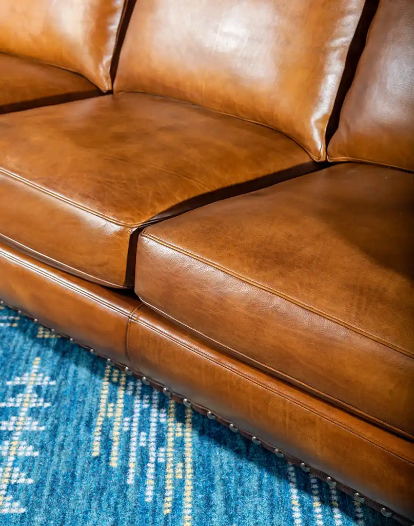 A view focusing on the deep, cushioned seating of the Norse Leather Sofa, designed for exceptional comfort.