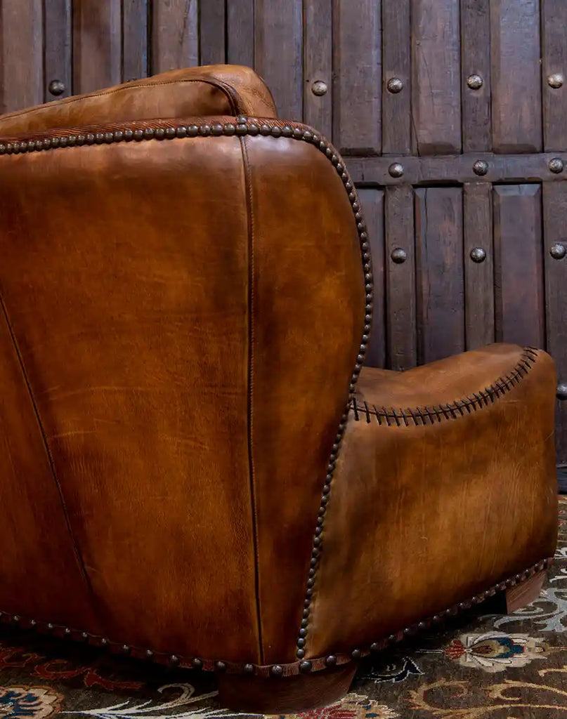 Close-up of the brass nail head detailing on the Cowboy Leather Sofa, adding a touch of rustic charm to its refined design.