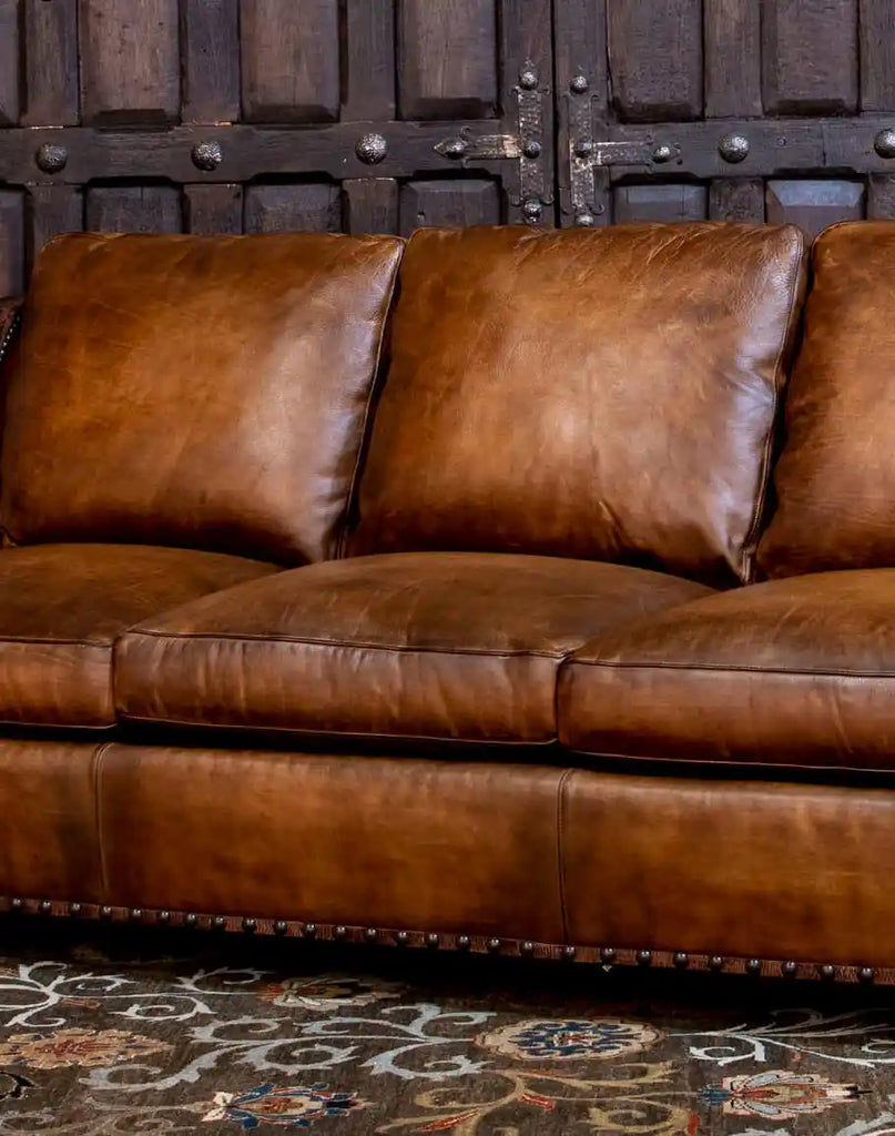 A detailed view of the premium leather upholstery on the Cowboy Leather Sofa, showcasing its rich texture and natural patina.