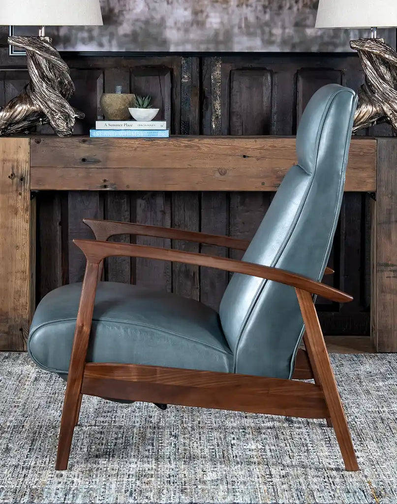 A side-angle view of the Daenerys Grey Leather Recliner, highlighting its smooth reclining mechanism, padded armrests, and sleek design.