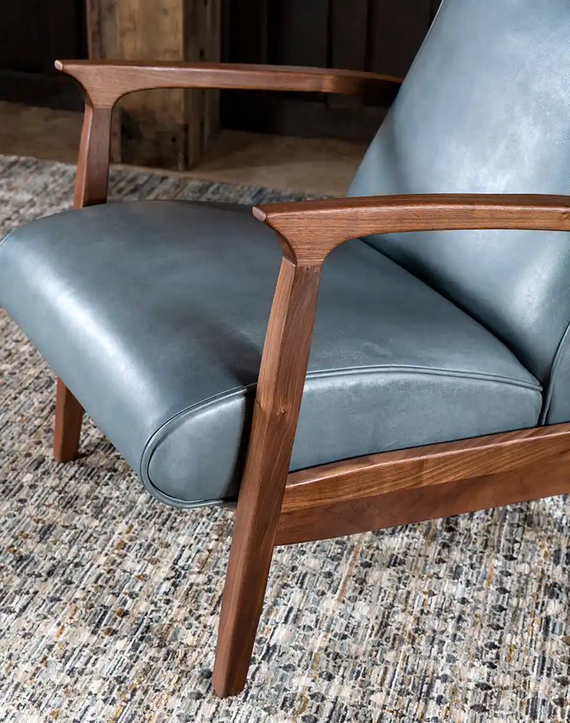 A close-up of the solid wooden legs on the Daenerys Grey Leather Recliner, featuring a hand-finished stain that complements the leather upholstery.