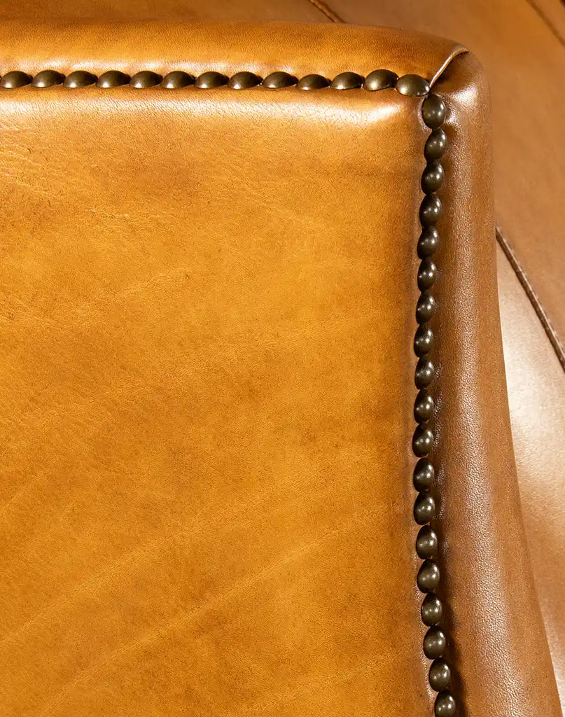 Detailed shot focusing on the rich, hand-burnished tan leather texture of the Dakota Saddle Recliner.