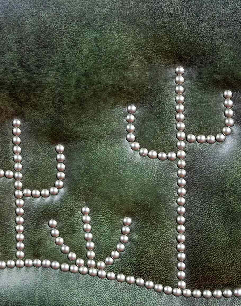 An artistic close-up of the cactus-shaped nickel nail trim on the Dark Green Cacti Bed, highlighting the whimsical and intricate design.