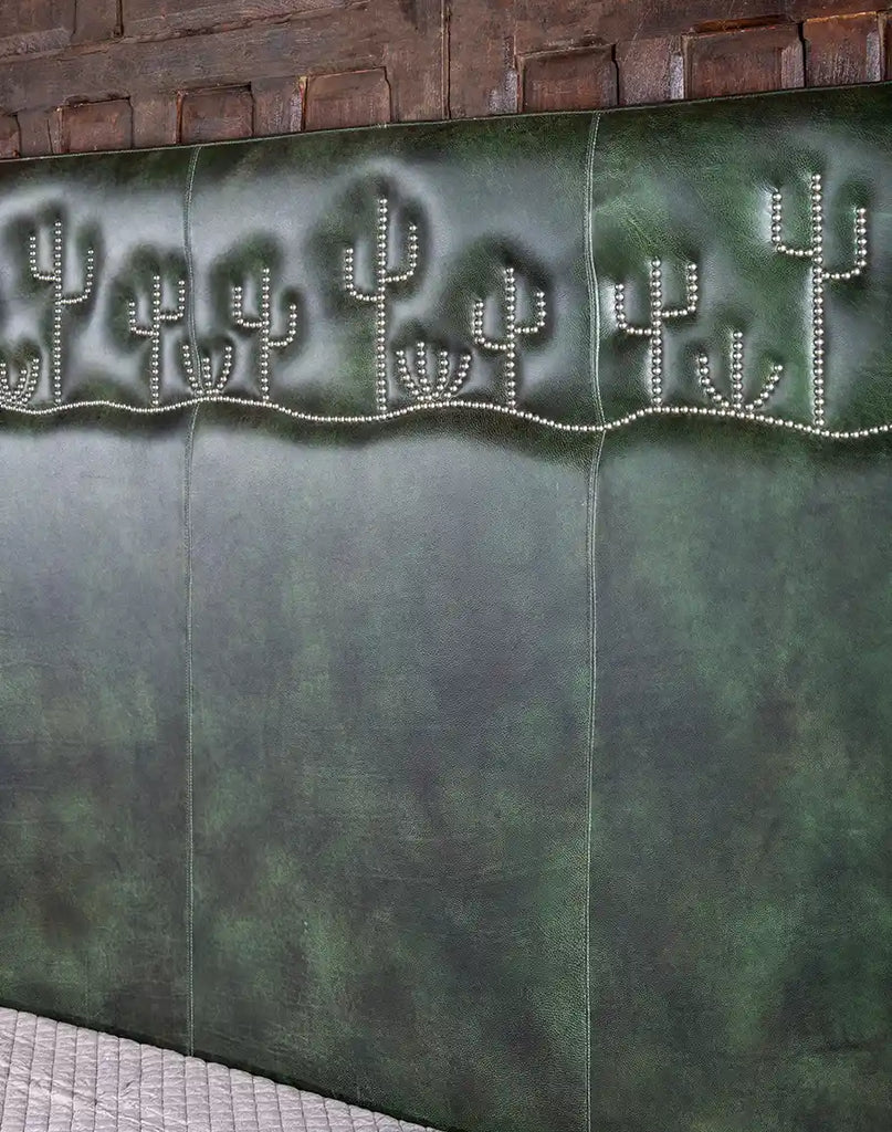 A close-up of the sumptuous dark green leather upholstery on the Dark Green Cacti Bed, emphasizing its rich texture and high quality.