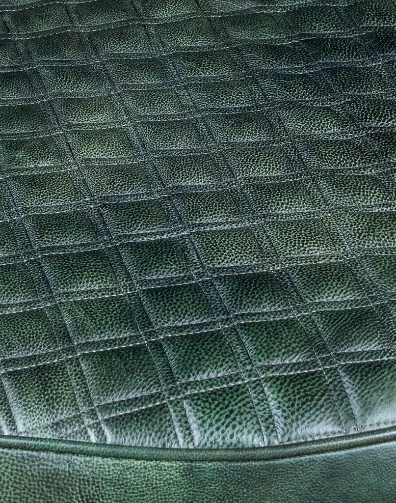 A close-up of the smooth and supple dark green leather top surface on the Dark Green Cacti Ottoman, perfect for comfort and style.