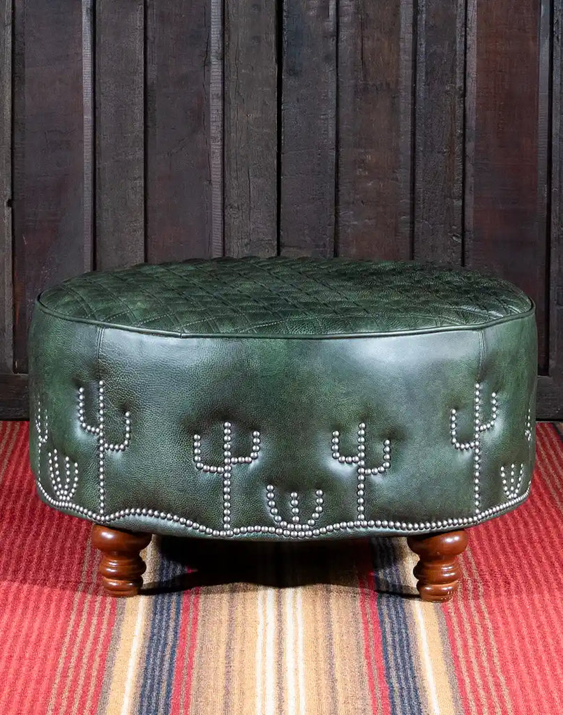 A close-up of the robust wooden legs of the Dark Green Cacti Ottoman, featuring a dark finish that complements the leather upholstery.