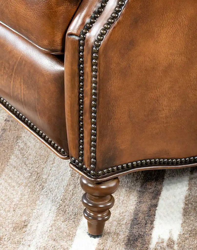 Close-up of the dark wooden legs of the Byron Leather Recliner, featuring a sturdy design and a rustic finish that complements its elegant leather upholstery.