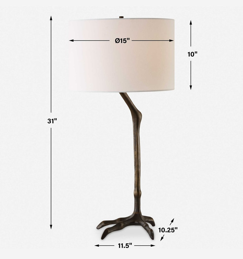 Elegant table lamp featuring a bird-leg design in antique bronze cast iron with a relaxed yet polished white linen fabric drum shade.