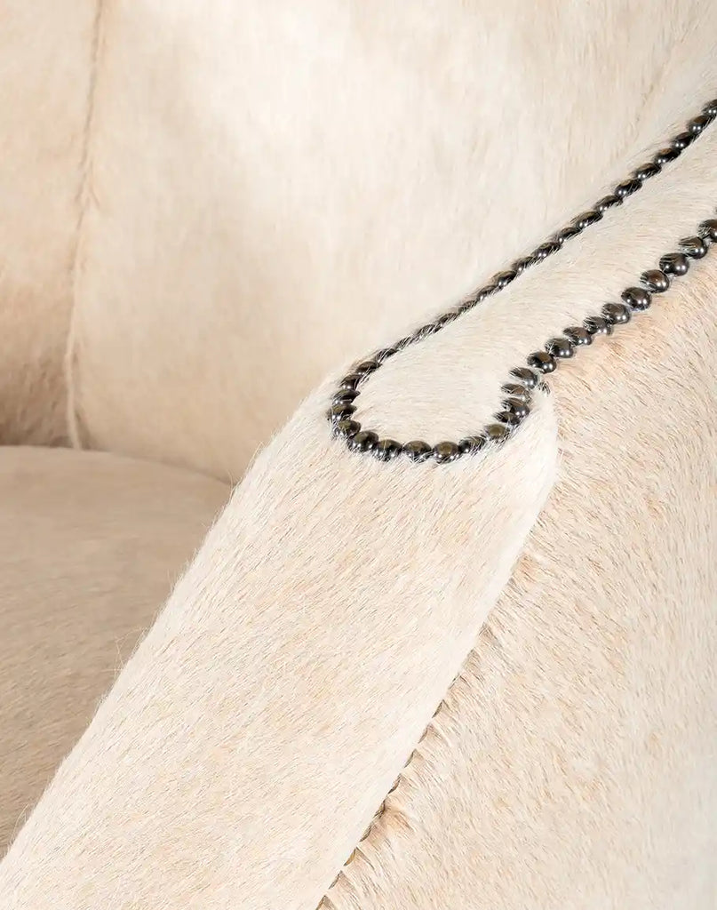 A close-up of the chair's padded armrest, crafted with premium cowhide and smooth finishing.