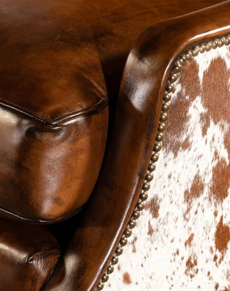 A detailed view of the brass nail tacks on the Alanna Leather Chair, adding a refined touch to its rustic design.