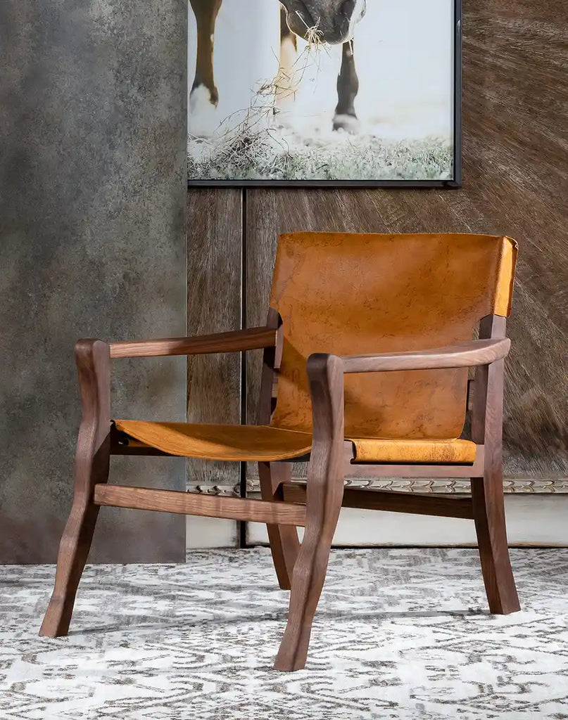 Diego Sling Chair featuring distressed leather and an oil-finished black walnut wood frame.