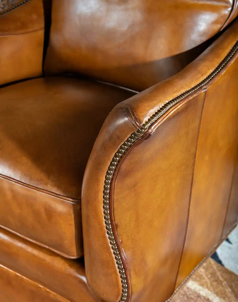 Close-up of the armrest, showcasing the fine stitching and leather quality of the Don Juan Swivel Glider.