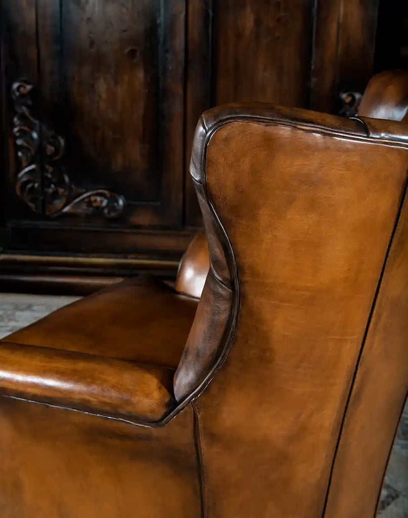 Side view displaying the sleek armrest design and smooth lines of the Donna Tufted Swivel Chair.