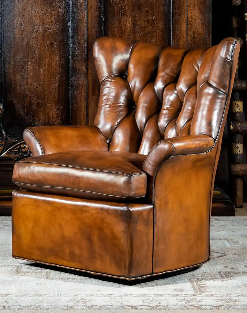 Front-facing image showcasing the full design of the Donna Tufted Swivel Chair, highlighting its hand-burnished leather and deep button tufting.