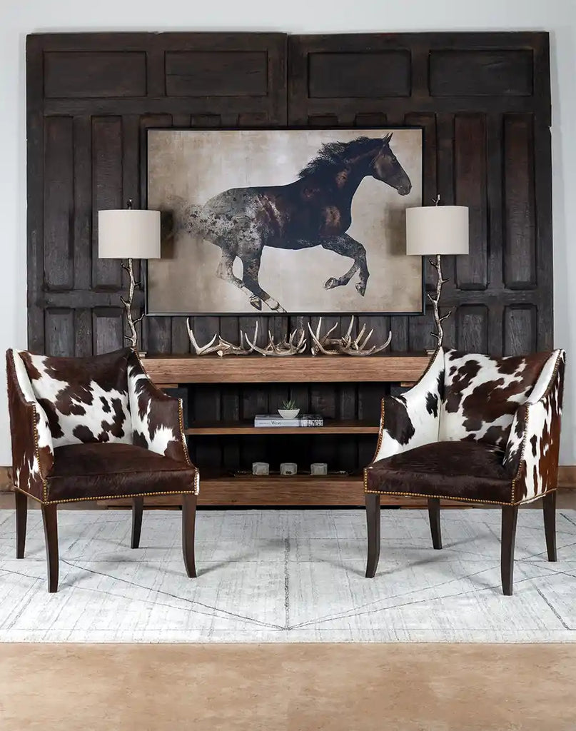 The Ebony Cowhide Chair styled in a cozy living room, showcasing its versatility and timeless Western appeal.