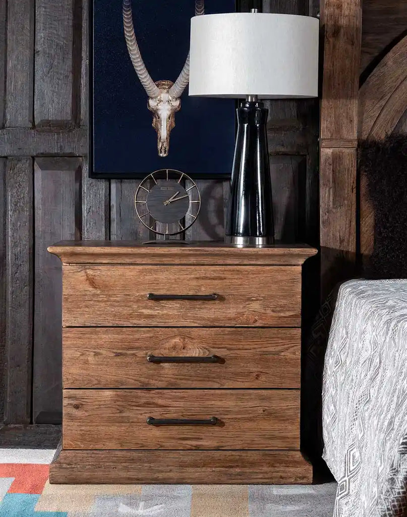 The El Paso Triple Drawer Nightstand styled in a cozy bedroom setting, adding a blend of traditional and modern aesthetics to the space.