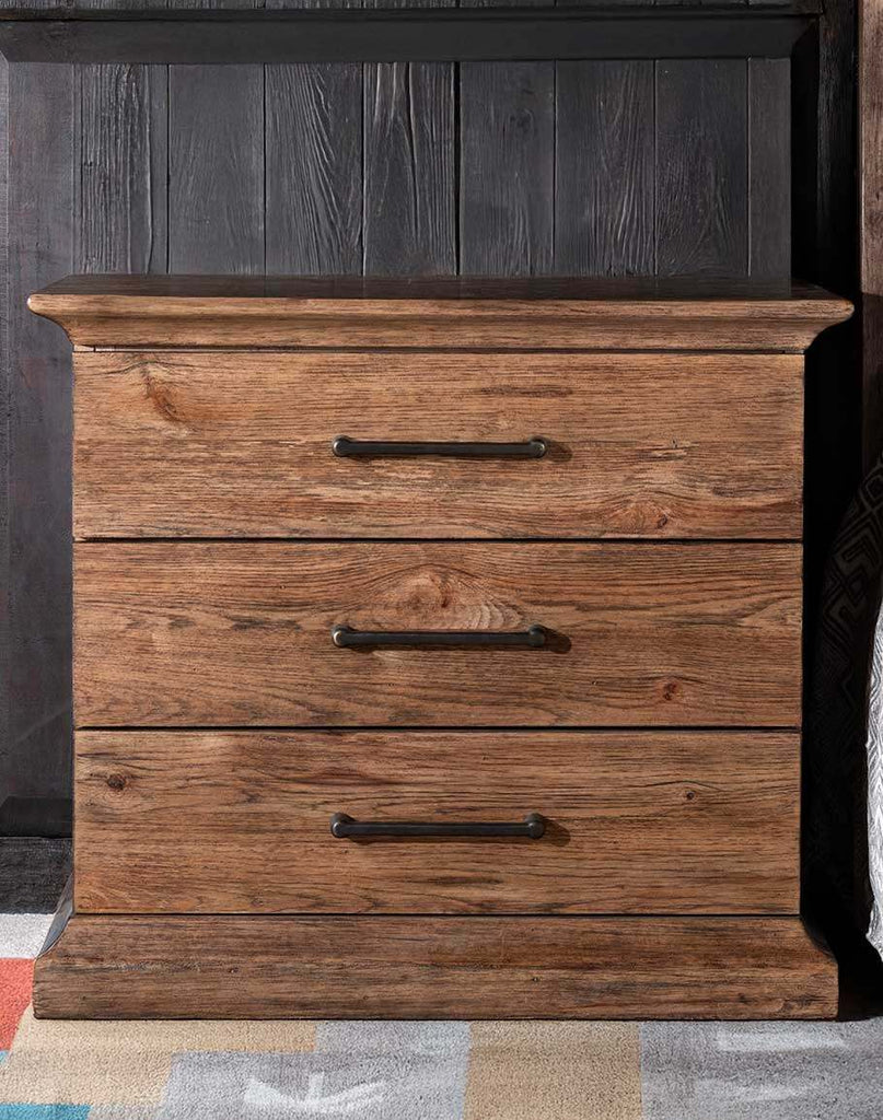 El Paso Triple Drawer Nightstand showcasing its Pecky Hickory Veneers, solid-wood-edged top, and dark brushed bronze bar pulls.