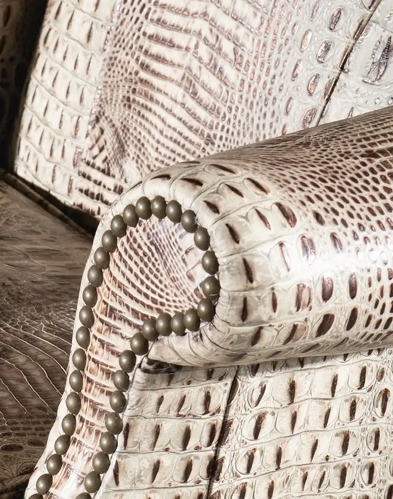 Close-up of the armrest on the Elise Executive Desk Chair, featuring stamped ivory croc leather and expert craftsmanship for added comfort and style.