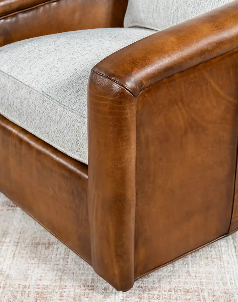 Close-up of the sturdy hardwood base and American-made ball bearing swivel mechanism of the Elsa Bark Swivel Chair.