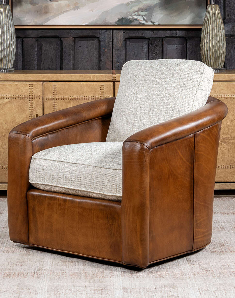 Elsa Bark Swivel Chair showcasing its luxurious full-grain leather exterior and soft ivory tweed cushions.