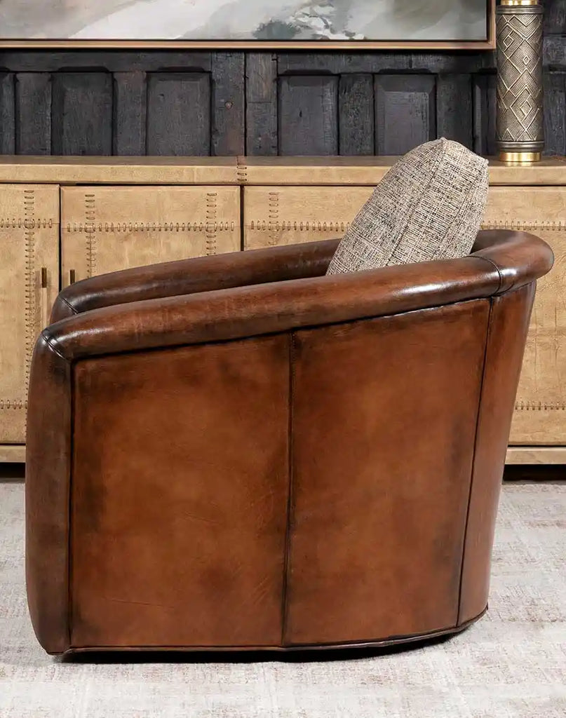 Side profile of the Elsa Cocoa Swivel Chair emphasizing its traditional 8-way hand-tied construction and robust hardwood frame.