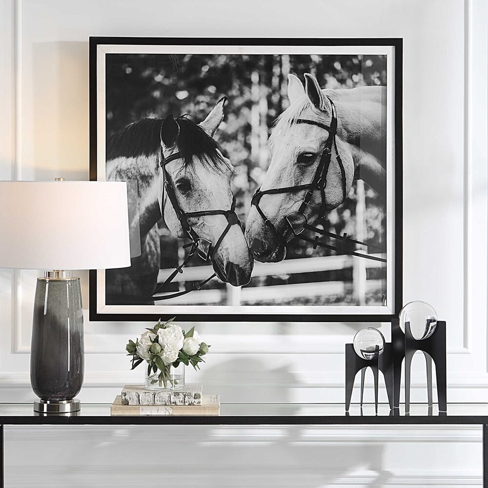 Framed black-and-white image of two horses facing each other, creating a serene and rustic aesthetic.