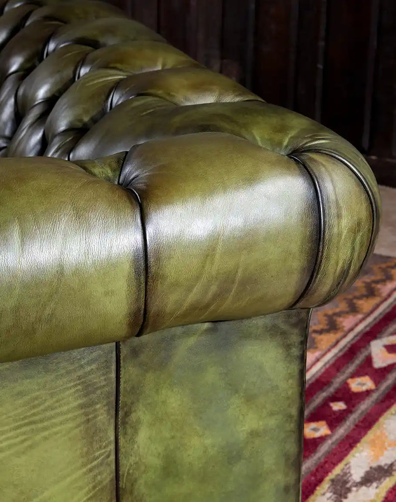 Close-up image of the hand-burnished olive leather, showing the rich texture and depth of color.