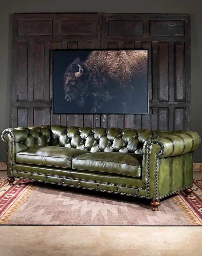 Side profile of the Evergreen Chesterfield Sofa highlighting the rolled armrests and brass nail tacks.