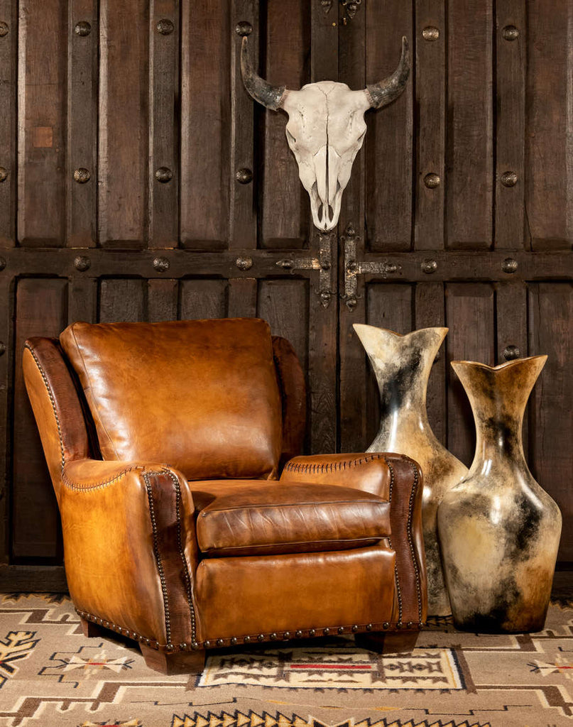 Full view of the Farmhouse Ranch Chair showcasing its aged leather upholstery, whip-stitched arms, and Western-inspired design.