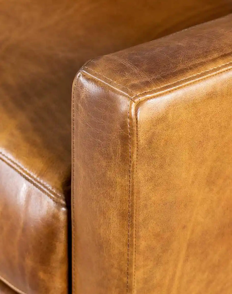 Detailed view of the sleek track arm design on the Fox Saddle Leather Sofa, showcasing its modern aesthetic.