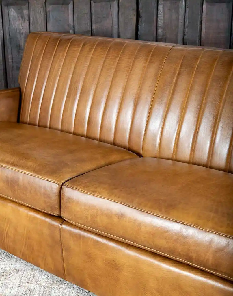 Close-up of the plush seat cushions of the Fox Saddle Leather Sofa, designed for ultimate comfort and durability.