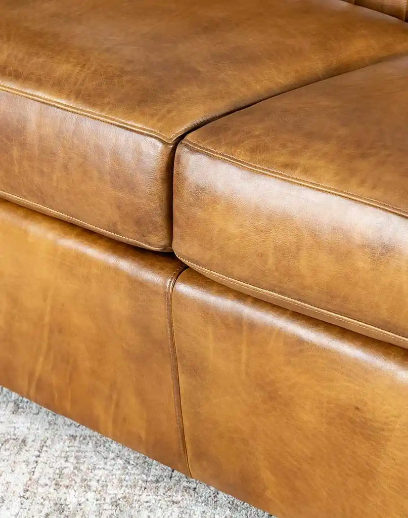 The Fox Saddle Leather Sofa arranged in a two-seat configuration, perfect for small and cozy living spaces.