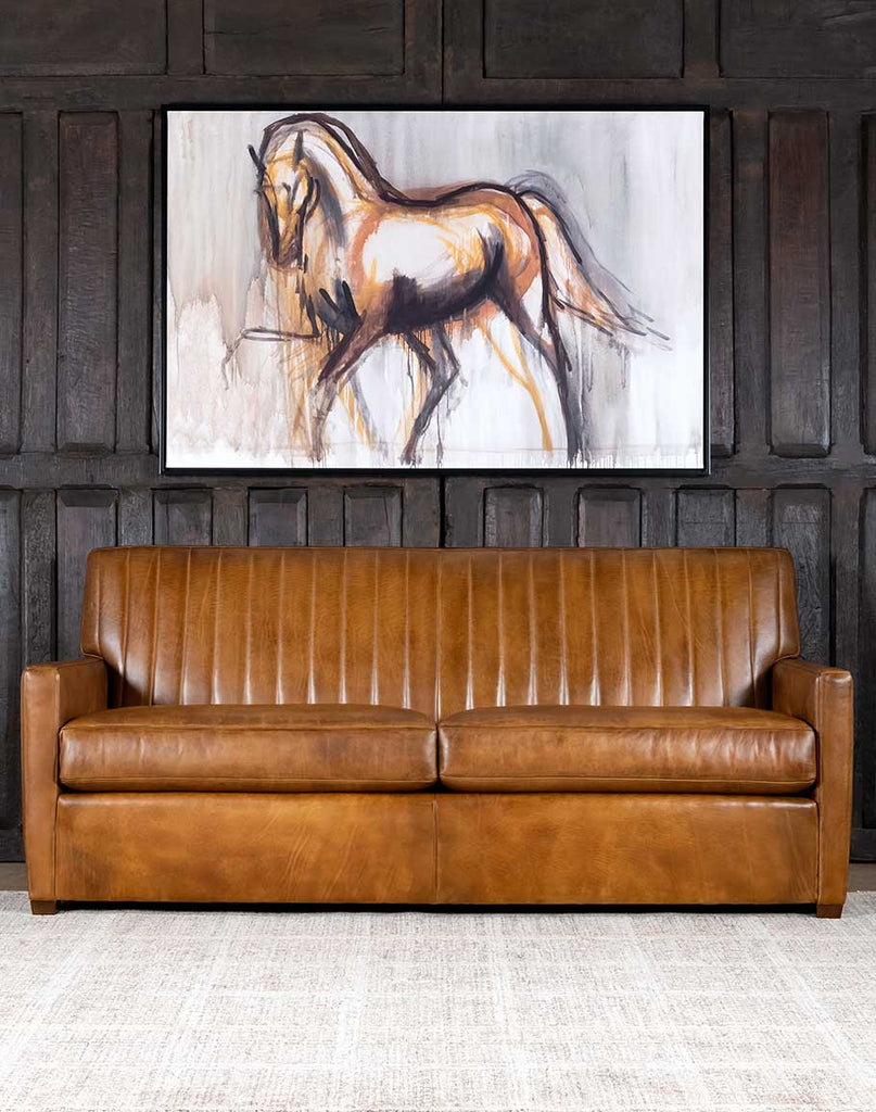 Fox Saddle Leather Sofa showcasing its luxurious full-grain leather in a rich saddle tan shade with padded stitch detailing.