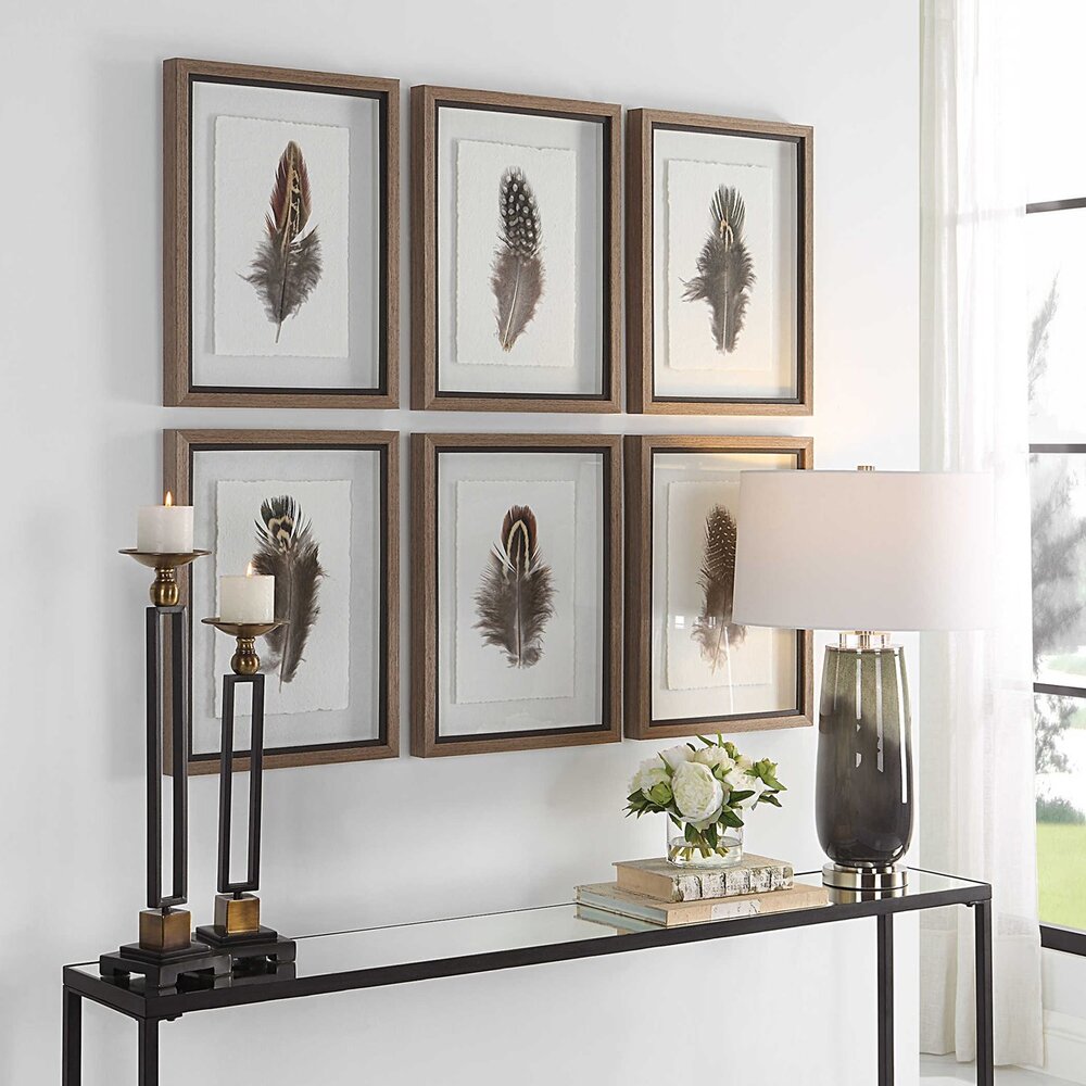 Framed feather artwork showcasing rich brown, cream, and charcoal hues with a distressed black liner.