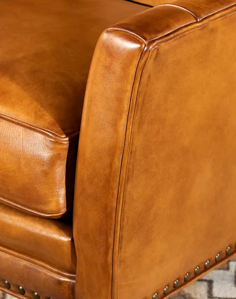 Detailed image focusing on the armrest, highlighting the fine stitching and hand-burnished leather of the French Leather Chair.