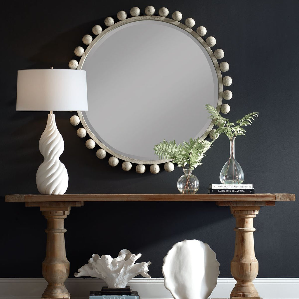 Aged Ivory Cyrus round wood mirror showcasing a distressed ivory frame with intricate detailing, perfect for adding rustic charm to any space.