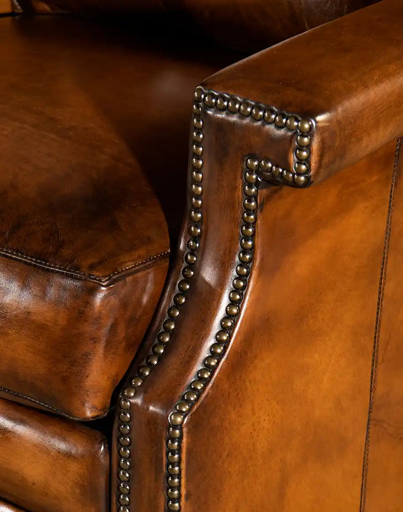 Zoomed-in view of the Gents Tan Leather Recliner’s armrest, featuring antique nailhead trim for a sophisticated touch.