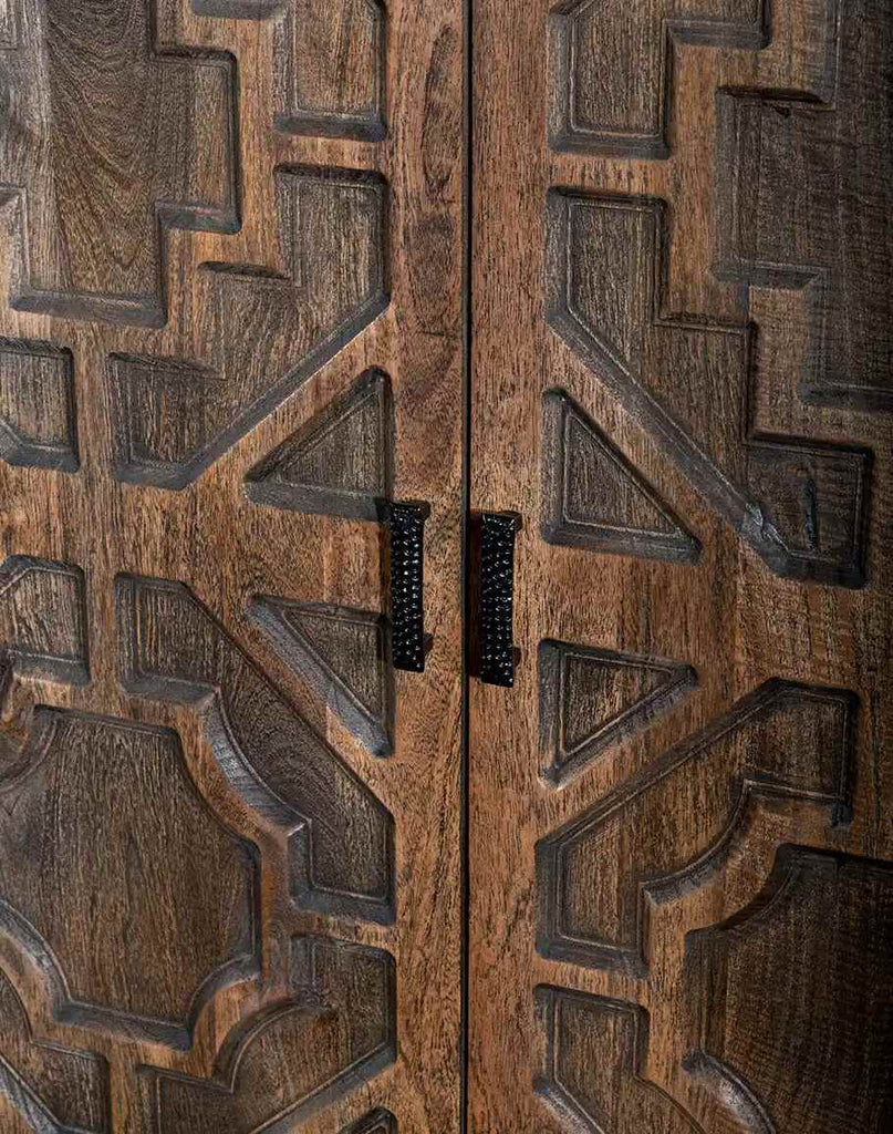 The antique brass hardware on the Geometric Carved Buffet doors, emphasizing the refined and elegant details.