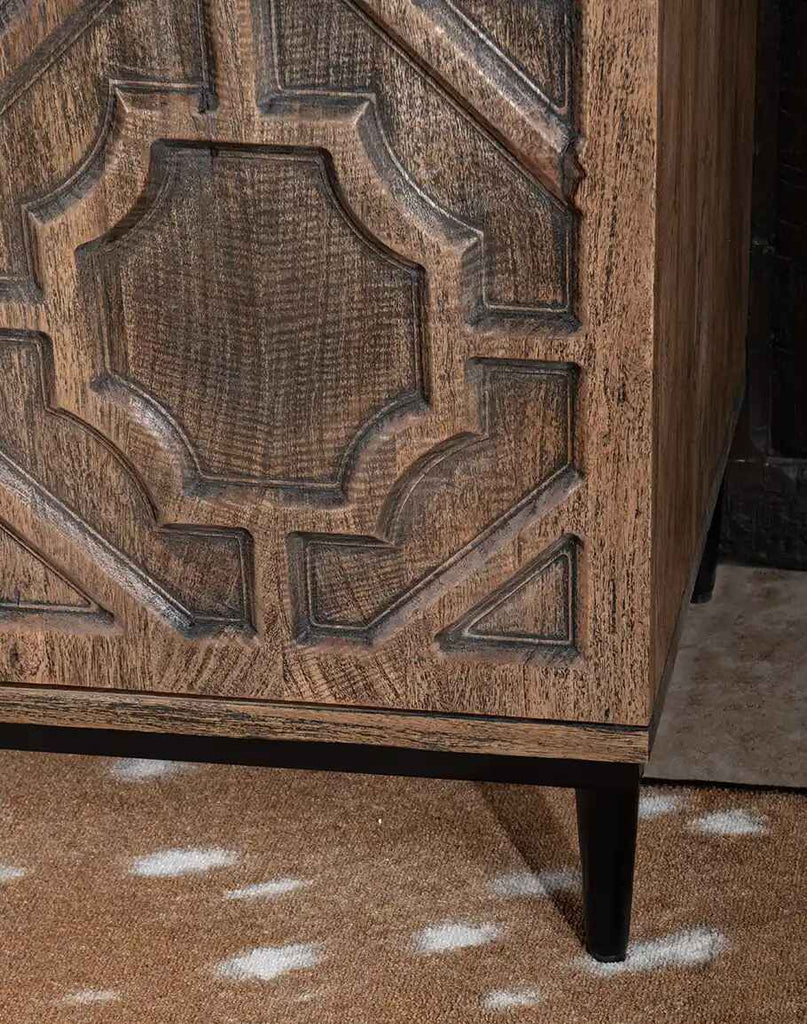 A close-up of the sleek metal base of the Geometric Carved Buffet, complementing the timeless design with a modern touch.