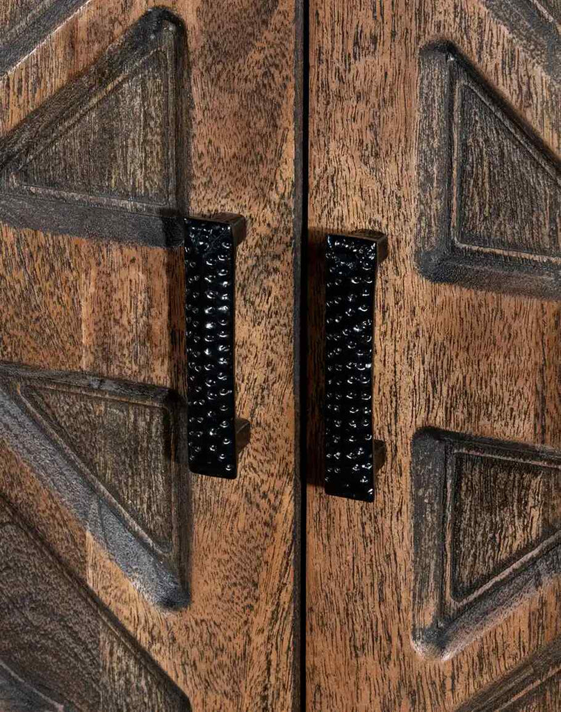 A close-up of the door facade on the Geometric Carved Buffet, featuring detailed geometric carvings and antique brass hardware.