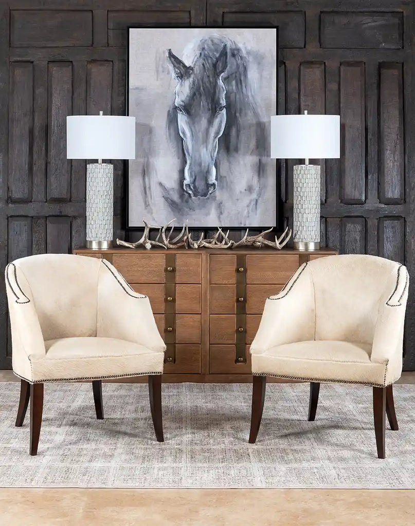 The Hertfordshire Sand Cowhide Chair placed in a stylish living room, complementing a rustic and modern interior.