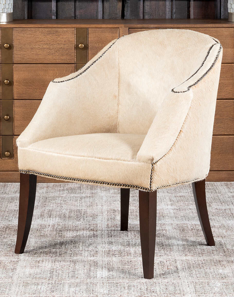 A front-facing view of the Hertfordshire Sand Cowhide Chair, showcasing its natural cowhide upholstery and sturdy hardwood frame.