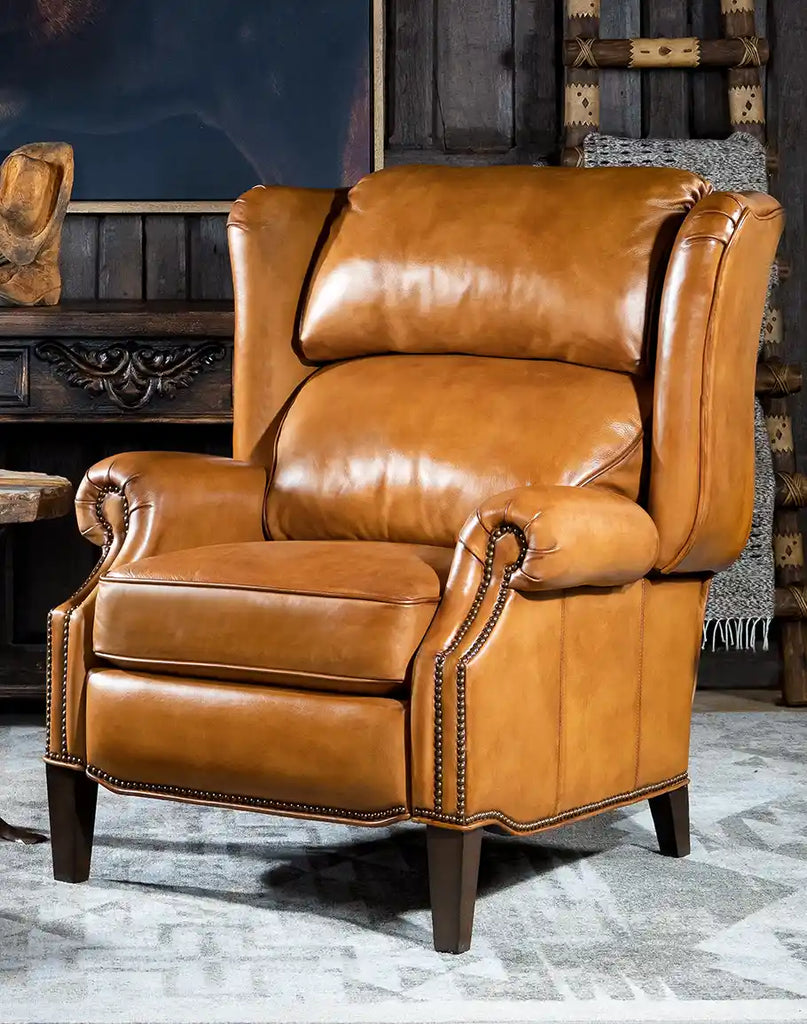 Luxurious Hollywood Leather Recliner in a rich brown hue, featuring a bustle back design and brass nailhead trim.